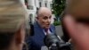 FILE - President Donald Trump's lawyer, Rudy Giuliani, speaks to reporters on the South Lawn of the White House in Washington, May 30, 2018.