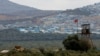 A Turkish military armored vehicle patrols on the border line located opposite the Syrian town of Atimah, Idlib province, in this picture taken from Reyhanli, Hatay province, Turkey, Oct. 10, 2017.
