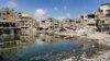 Sewage water from collapsed underground pipes covers an area by destroyed buildings in Khan Yunis in the southern Gaza Strip on July 8, 2024 amid the ongoing conflict in the Palestinian territory between Israel and Hamas.