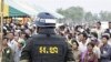 A Cambodian military policeman stands watch during the ground breaking ceremony of a Chinese funded road at Koun Damrey village, Banteay Meanchey province, about 15 kilometers (9 miles) east of Cambodia's border with Thailand, February 15, 2011.
