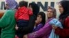 People queue to receive free food at a makeshift camp for migrants and refugees at the Greek-Macedonian border near the village of Idomeni, Greece, April 6, 2016. The U.N. refugee agency reports 65 million people were forcibly displaced last year.