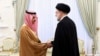 FILE - Saudi Arabian Foreign Minister Prince Faisal bin Farhan shakes hands with Iranian President Ebrahim Raisi in Tehran on June 17, 2023. Iran removed visa requirements for Saudi visitors, among others, on Dec. 14. (Office of the Iranian Presidency via AP)