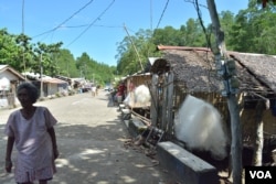 Fishing nets are hung outside of houses in this small fishing town along Ulugan Bay, which fronts the South China Sea in Bahile, Palawan province, Philippines. (Photo: Simone Orendain for VOA)