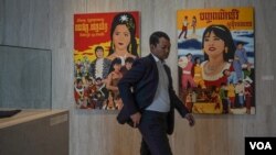A man walked past movie posters at the 2019 Cambodia International Film Festival in Phnom Penh, Cambodia, March 12, 2019. (Khan Sokummono/VOA Khmer) 