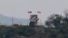 FILE - In this May 3, 2020, file photo, a North Korean flag flutters in the wind at a military guard post in Paju, at the border with North Korea. North Korea on Friday, May 8, slammed South Korea for staging what it called "reckless" military…