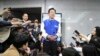 FILE - South Korea's main opposition Democratic Party leader Lee Jae-myung, center, speaks to reporters after watching results of exit polls for the parliamentary election at the National Assembly on April 10, 2024 in Seoul, South Korea.