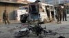 Afghan security personnel stand guard at the site of suicide bomber attack in the city of Jalalabad, east of Kabul, Dec. 3, 2017. 