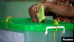 A voter cast her ballot for the by-election in Yangon, Myanmar, November 3, 2018. REUTERS/Ann Wang