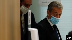 Former French President Nicolas Sarkozy leaves the courtroom in Paris, March 1, 2021. A Paris court found him guilty of corruption and influence peddling and sentenced him to one year in prison, Sep 30, 2021. 