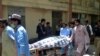 Hospital workers push a stretcher carrying the body of a policeman who was one of the policemen shot dead in Quetta, Pakistan, July 13, 2017.