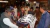 Volunteers carry the body of a shooting attack victim, at a hospital in Quetta, Pakistan, April 2, 2018.