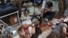 Wounded men receive treatment at a local clinic after airstrikes hit in Aleppo, Syria, Sept. 24, 2016. 