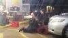 FILE - Image made from video shows Alton Sterling being restrained by two Baton Rouge police officers, one holding a gun, outside a convenience store in Baton Rouge, Louisiana, July 5, 2016, before one of the officers shot and killed Sterling, a black man who had been selling CDs outside the store, while he was on the ground. 