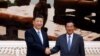 Chinese President Xi Jinping and Cambodian Prime Minister Hun Sen shake hands as they pose for a picture at the Prime Minister's office in Phnom Penh, October 13, 2016.