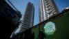 FILE - Residents walk by a luxury housing construction site in Beijing, Sept. 24, 2024. Over the past few months, regulators have rolled out a slew of policies meant to help reverse the downturn in the housing market and encourage more spending by Chinese households. 