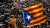Thousands of people rally outside the regional presidential palace in Sant Jaume Square during a general strike in Barcelona, Spain, Nov. 8, 2017. 