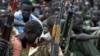 Boys with their rifles sit at a ceremony of the child soldiers disarmament, demobilization and reintegration in Pibor, Jonglei State, South Sudan, oversawn by UNICEF and partners, Feb. 10, 2015.