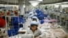 FILE - North Korean workers assemble jackets at a factory of a South Korean-owned company at the jointly run Kaesong Industrial Complex in Kaesong, North Korea, Dec. 19, 2013.