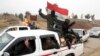 Shi'ite fighters of the Popular Mobilization Forces patrol in a neighborhood recently liberated from Islamic State militants in the eastern Mosul, Iraq, Jan. 25, 2017.