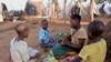 FILE - Mozambican child refugees prepare food at Kapise camp in Malawi's Mwanza district, Jan. 18, 2016.