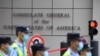 Policemen walk past the US consulate in Chengdu, southwestern China's Sichuan province, on July 26, 2020. - Tensions have soared between the two powers on a range of fronts including trade, China's handling of the novel coronavirus and a tough new…