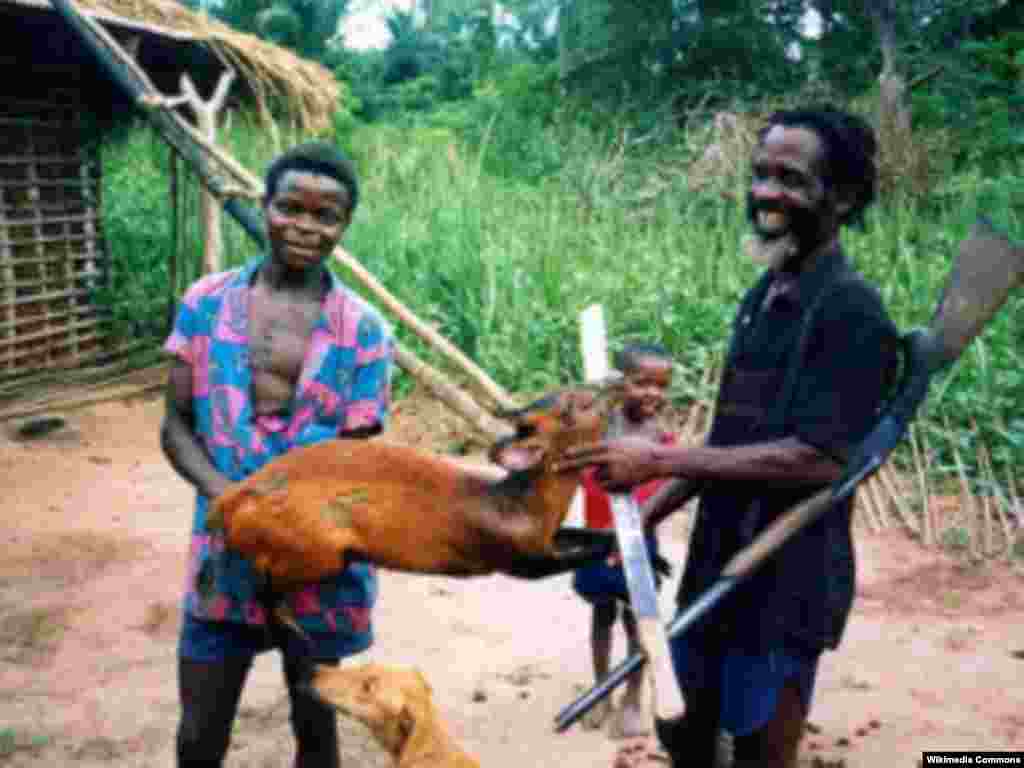 Un chasseur troque l’antilope qu’il a tuée, avec d’un habitant d’un village africain.
