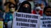 FILE-A Muslim woman holds a placard against remission of sentence by the government to men convicted of a gang rape of a Muslim woman in communal violence in 2002 in western Gujarat state, during a protest in New Delhi, India, Aug. 27, 2022.