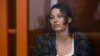 Ksenia Karelina, who is Russian American, sits in a glass cage in a court room in Yekaterinburg, Russia, on June 20, 2024. She is accused of treason.