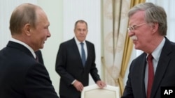 Le président russe Vladimir Poutine, à gauche, et le conseiller américain à la Sécurité nationale, John Bolton, lors de leur rencontre au Kremlin à Moscou, le 27 juin 2018.