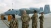 U.S air force personnel stand by an U.S. A-10 aircraft, one of a squadron that arrived at the Kandahar air base, Afghanistan, Jan. 23, 2018.