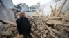 A man inspects a damaged building after an earthquake at Dahejia in Jishishan County in northwest China's Gansu province on Dec. 20, 2023.