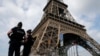 FILE - French police patrol near the Eiffel tower as part of security measures in Paris, France, July 13, 2017. 