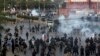 Pakistan police officers fire tear gas shell to disperse Shi'ite Muslims during an anti-U.S rally, when they tried to march toward the U.S. consulate, in Karachi, Pakistan, Aug. 27, 2017.