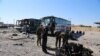 Iraqi security forces inspect the site of a blast where a suicide bomber detonated his explosives-laden ambulance in Iraq's holy city of Samarra, north of Baghdad, Nov. 6, 2016. 