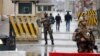 Afghan security forces keep watch at a checkpoint near the site of a suicide attack in Kabul, Afghanistan, Feb. 24, 2018. 