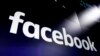 FILE - In this March 29, 2018, file photo, the logo for Facebook appears on screens in New York's Times Square. Facebook is defending itself against allegations that it allows illegal content in violation of Vietnam’s cybersecurity law. The social…