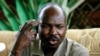 FILE - Ahmed Harun, then-governor of South Kordofan, a Sudanese province, gestures during a press conference in Talodi, South Kordofan, April 12, 2012. 