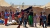 Internally displaced civilians from Fallujah flee their homes during fighting between Iraqi security forces and Islamic State group during a military operation to regain control of the city, outside Fallujah, 40 miles (65 kilometers) west of Baghdad, Iraq, Thursday, May 26, 2016. 