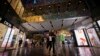FILE - People shop at Taikoo Li Sanlitun in Beijing, China, July 2, 2024. 