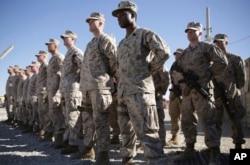 FILE - U.S. Marines stand guard during a change-of-command ceremony at Task Force Southwest military field at Shorab military camp in Helmand province, Afghanistan, Jan. 15, 2018.