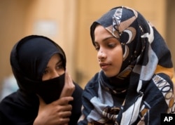 An elder sister of Zainab Ansari, left, consoles her younger sister in Kasur, Jan. 18, 2018.
