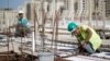 FILE - Palestinian laborers work at a construction site in Rawabi, near the West Bank city of Ramallah, Oct. 27, 2013.