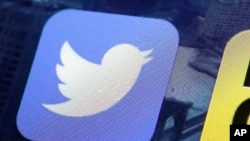 FILE -Twitter app on an iPhone screen in New York, Oct. 18, 2013.