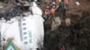 FILE - A rescue team works to recover the body of a victim from the site of the plane crash of a Yeti Airlines operated aircraft, in Pokhara, Nepal Jan. 16, 2023.