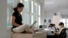 FILE - Employees are seen working on their computers at an office in Singapore May 24, 2012. Singapore placed first in a list of technologically advanced countries as ranked by a just released World Economic Forum report. 