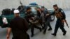 Afghan policemen carry an injured man after a blast in Kabul, Afghanistan, Oct. 31, 2017. 