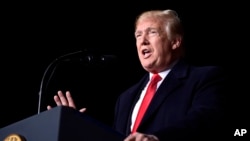 President Donald Trump speaks at a rally at Central Wisconsin Airport in Mosinee, Wis., Oct. 24, 2018. 