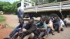 A policeman stands guard as some of the people arrested during demonstrations over the hike in fuel prices, make their court appearance at the magistrates courts in Harare, Zimbabwe, Wednesday, Jan,16, 2019. 