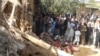FILE - Students gather at the site of a U.S. drone strike on an Islamic seminary in Hangu district, bordering North Waziristan, Pakistan, Nov. 21, 2013. The strike killed a senior member of the Taliban-linked Haqqani network.
