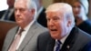 Secretary of State Rex Tillerson (L) listens as President Donald Trump announces that the United States will designate North Korea a state sponsor of terrorism, during a cabinet meeting at the White House, Nov. 20, 2017, in Washington.